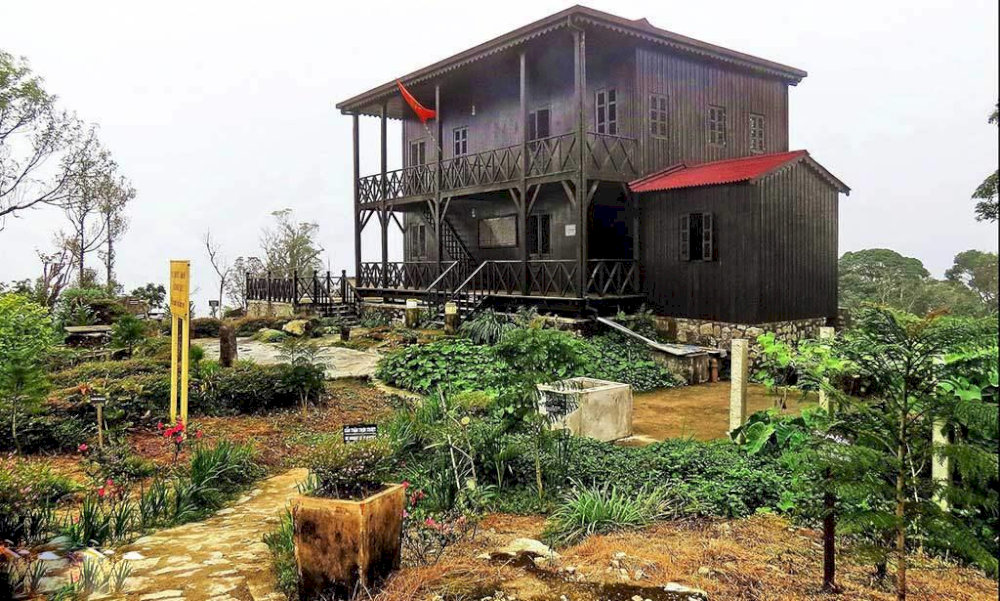 A tranquil replica of Dr. Yersin’s retreat on Hon Ba Peak, surrounded by lush greenery and misty mountains